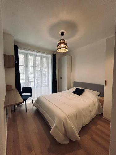 a bedroom with a large white bed and a window at Maison et chambre privée - Bordeaux in Bordeaux