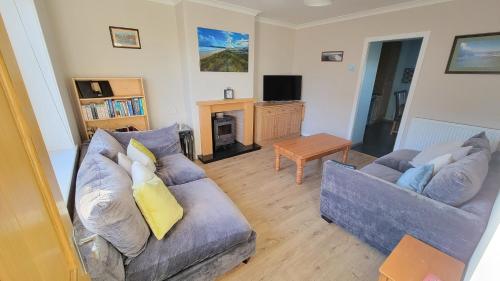a living room with two couches and a television at Stornoway Stays in Stornoway