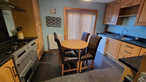 a kitchen with a small table and chairs in it at Stornoway Stays in Stornoway