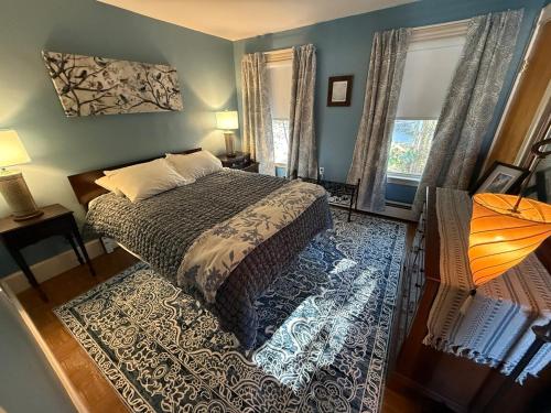 a bedroom with a large bed and a window at Gallows Hill Guest House in Salem