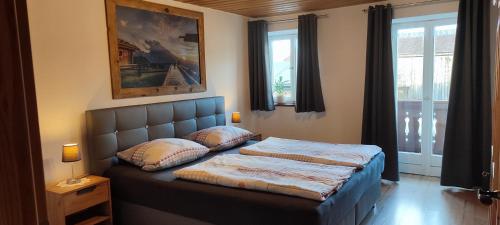 a bedroom with a bed with two pillows on it at Vorderwahllehen in Schönau am Königssee