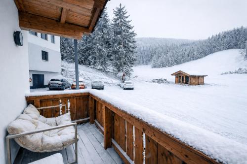 a balcony with a view of a snow covered yard at OLDWOOD CHALET - AlpenLuxus Collection in Fügen