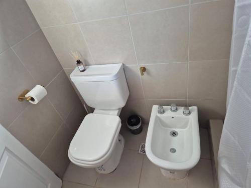 a small bathroom with a toilet and a bidet at Mardel Chapla in Colonia Chapadmalal