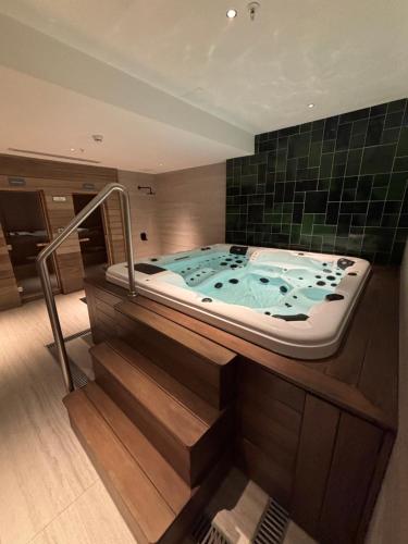 a jacuzzi tub in a room with green tiles at Sea Garden Tower 2 in Punta del Este