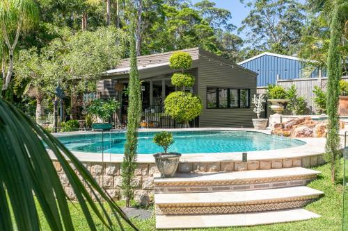 a house with a swimming pool in a yard at Noosa Valley Manor B&B in Doonan