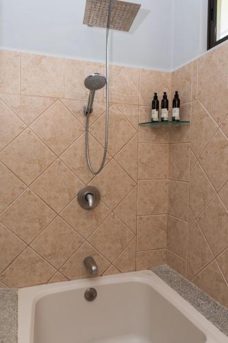 a shower in a bathroom with a tub at Corteza 2BD Gated AC Quiet Terrace Pools in Jacó