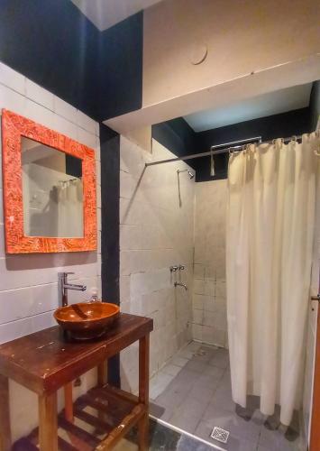 a bathroom with a sink and a shower at Huaka Guesthouse and Hostel in Cafayate