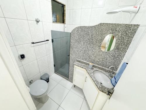 a bathroom with a sink and a toilet at Apto na beira da praia do Centro | ROMM109 in Rio das Ostras