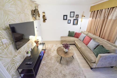 a living room with a couch and a table at Jubilee View - New! Luxurious Home, Parking Wi-Fi in Bury