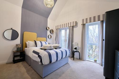 a bedroom with a large bed and a window at Jubilee View - New! Luxurious Home, Parking Wi-Fi in Bury