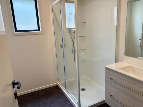 a bathroom with a shower and a sink at 45 degrees South in Kakanui