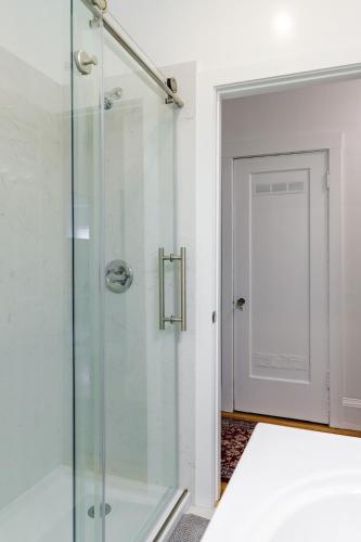 a shower with a glass door in a bathroom at 2 - Berkeley Private 1 Bedroom Apartment with Laundry in Berkeley