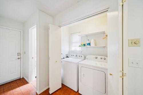 a white laundry room with a washer and dryer at Heart of Tulsa, pool, game room, Sleeps 8 in Tulsa