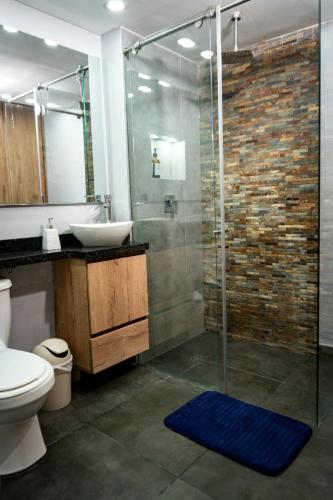 a bathroom with a sink and a glass shower at Apartamento Moderno en Villeta - Nido de San Miguel in Villeta
