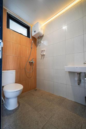 a bathroom with a toilet and a sink at Naava Village in Tagalbato