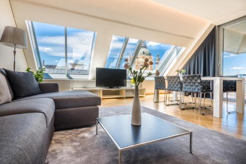 a living room with a couch and a table at Hotel Moments Budapest by Continental Group in Budapest