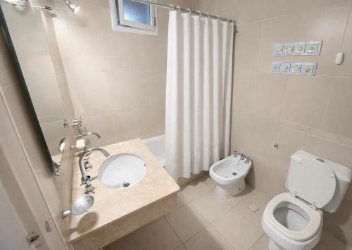 een badkamer met een wastafel, een toilet en een douche bij Hostel Valle Grande in San Rafael