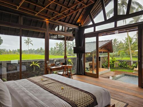 a bedroom with a large bed and a pool at Sanis House in Penginyahan