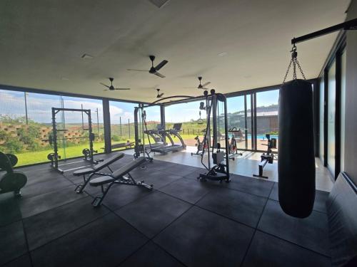 une salle de sport avec des balançoires et des tapis roulants dans un bâtiment dans l'établissement FezatOceanZimbali, à Ballito