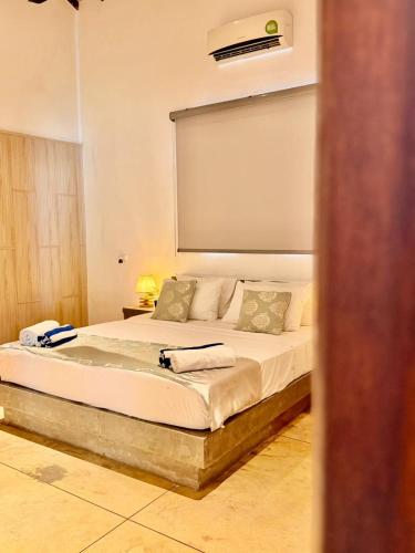 a bedroom with a bed with a tub in it at Luvora Villa in Ambalangoda