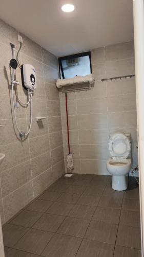 a bathroom with a shower and a toilet at Seaview mutiara melaka Pantai puteri in Gua Sai