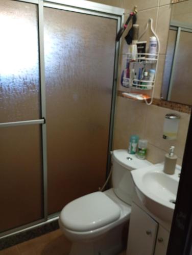 a bathroom with a toilet and a shower and a sink at Eternal Sun in Balneario Buenos Aires