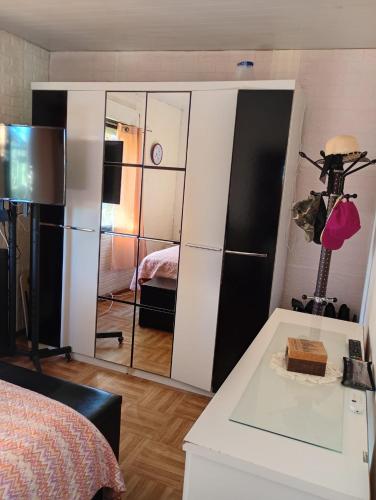 a bedroom with a large mirror and a bed at Eternal Sun in Balneario Buenos Aires