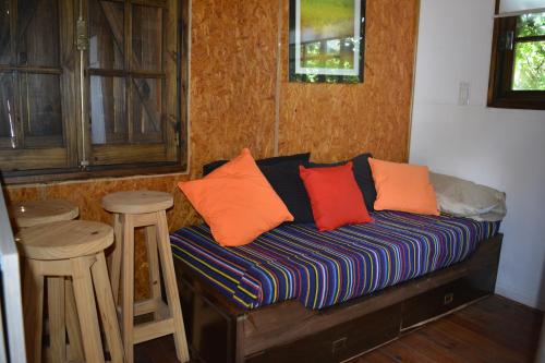 a couch with pillows on it in a room at Orejano in Mercedes