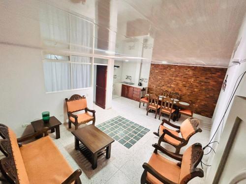 a living room with chairs and a dining room at Casa Nobsa ArteSana in Nobsa
