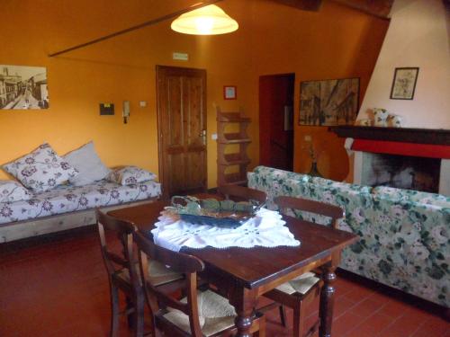 a living room with a table and a couch at Badia il Vingone in Città di Castello