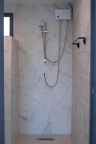 a bathroom with a shower with white marble at Mosch Apartments in Noord