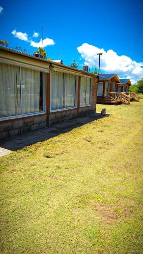 a house with windows on the side of a yard at Las Amapolas in Villa Giardino