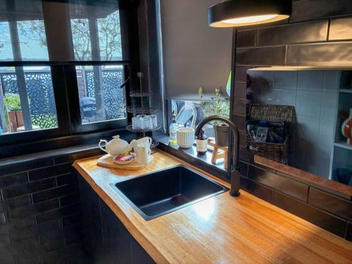 a kitchen with a sink and a counter top at Courtyard Pool Studio Private Luxe Retreat in Coal Point