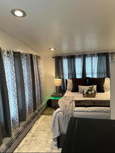 a bedroom with a large bed with blue curtains at Private Garden Suite in Bayshore in Bay Shore