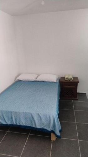 a bedroom with a bed and a night stand with a phone at Estudio De La Cinco Puerto Vallarta in Puerto Vallarta