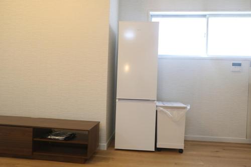 a white refrigerator in a room with a window at Near Mitaka Museum of Art in Mitaka