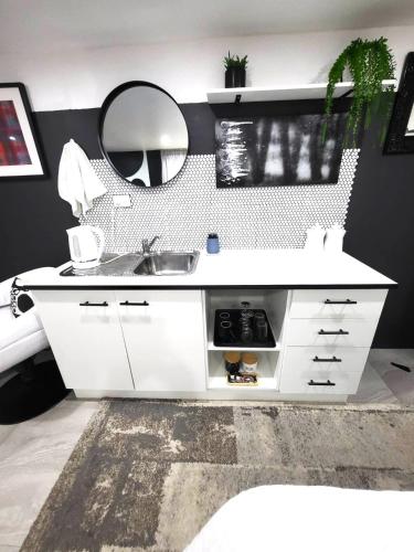 a bathroom with a sink and a mirror at Hidden Gem - 10 Mins To Wineries 3 Bedroom in Cessnock