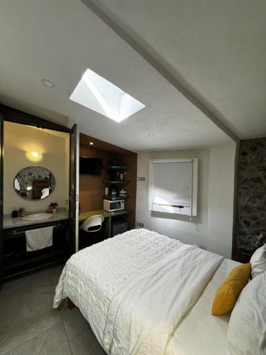 a bedroom with a large bed and a bathroom at Apolonia en ValQuirico in Santeagueda