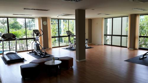 an empty room with a gym with wood floors and windows at LPN Cha-am Beachfront Wifi 10 meters to beach 1BR ติดทะเล in Cha Am