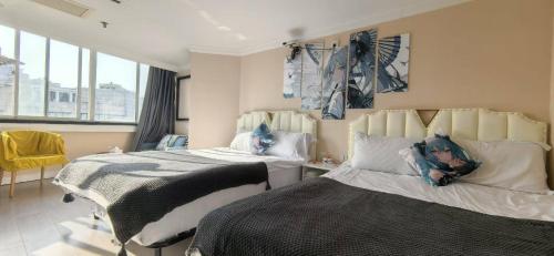a bedroom with two beds with pillows at Maizi Apartment Homestay, Shanghai in Shanghai