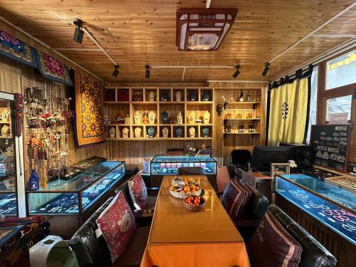 a restaurant with tables and chairs and a bar at Yi's Hostel in Shangri-La