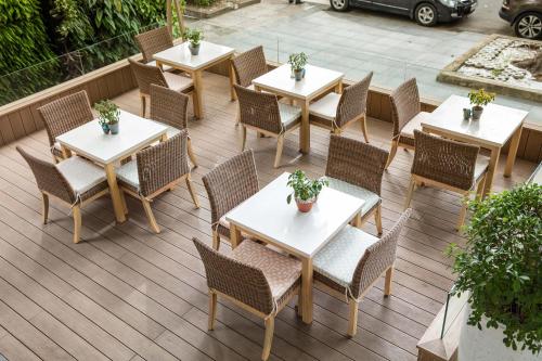 a group of tables and chairs on a patio at Fusion Suites Saigon in Ho Chi Minh City