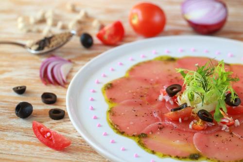 a plate of food on a wooden table at Jimbaran Bay Beach Resort and Spa by Prabhu in Jimbaran