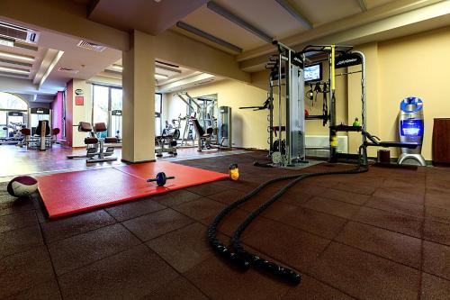 a gym with a red yoga mat on the floor at Primoretz Grand Hotel & Spa in Burgas City