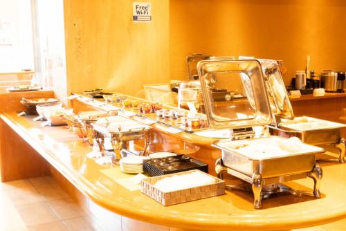 eine Küche mit Theke mit viel Geschirr in der Unterkunft New Grand Hotel in Shinjo