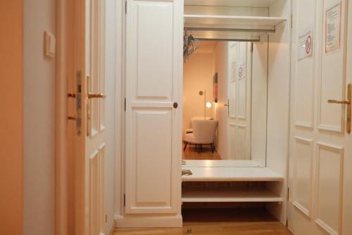 a hallway with a mirror and a white door at Hotel Restaurant Der Greif in Leoben