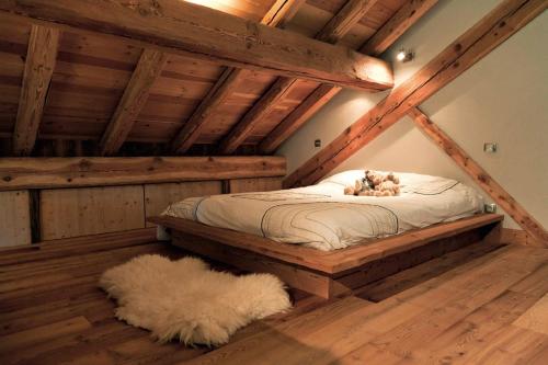 a dog laying on a bed in a attic at Les Alpages d'Auguste in Valloire
