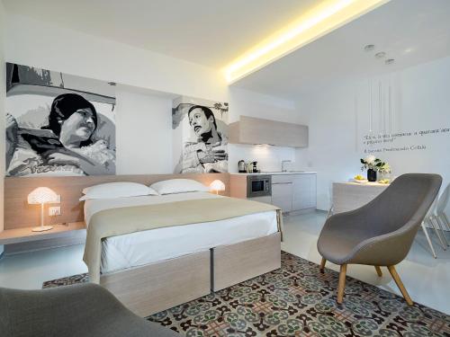 a bedroom with a large bed and a kitchen at Duomo Suites & Spa in Catania