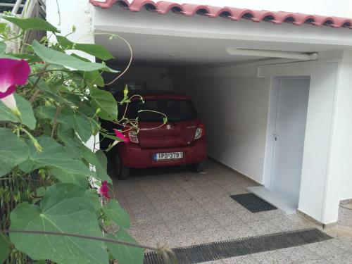 a red car is parked in a garage at Best location in Vrachati in Vrahati