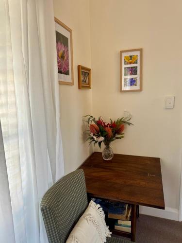 a room with a table and a vase of flowers at York Wildflower Junior Suite in York